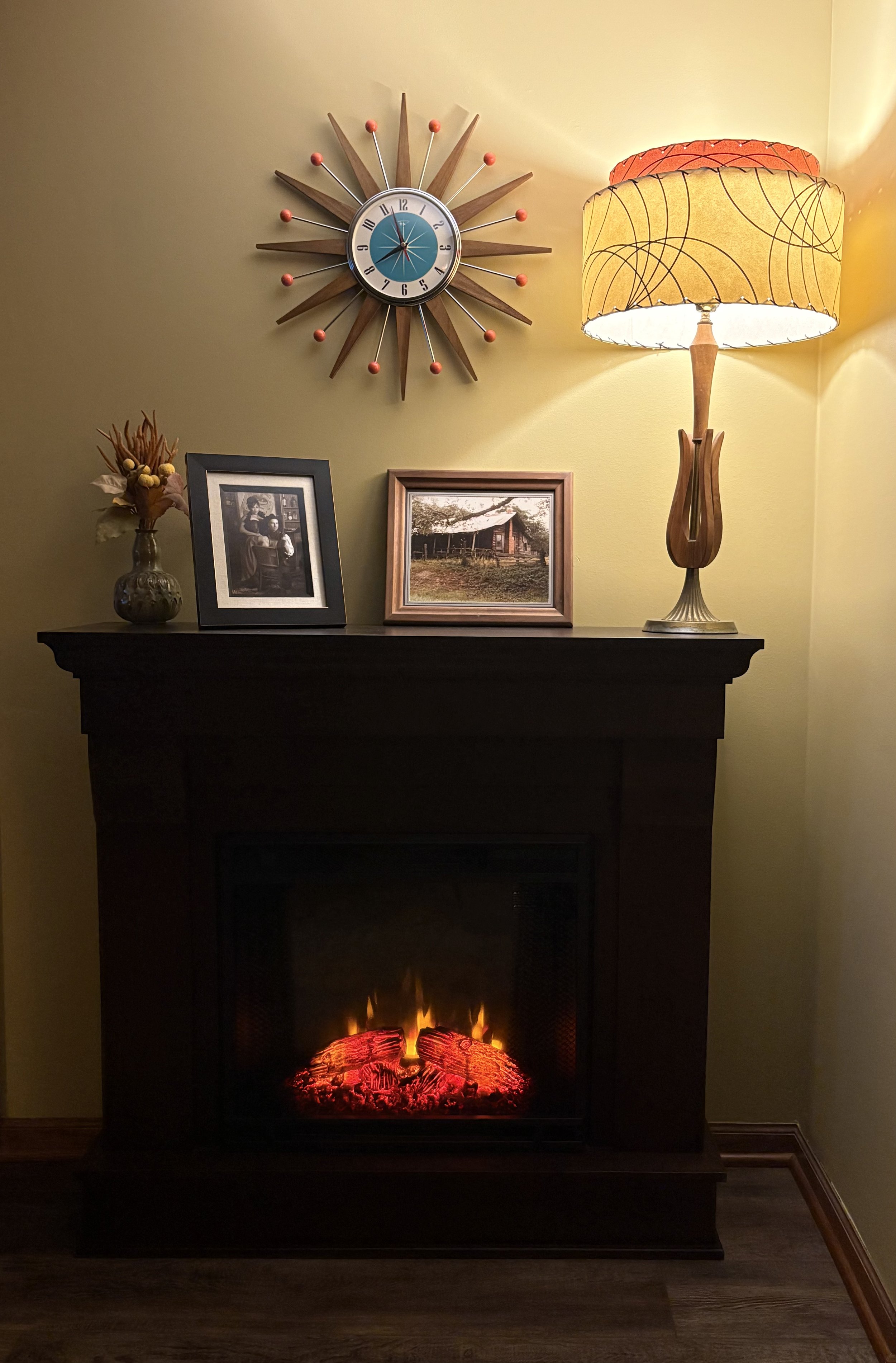 Studio fireplace with atomic starburst clock and retro lamp